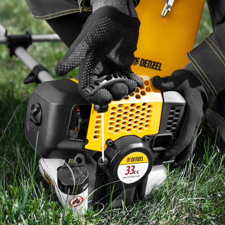 Person holding a Denzel grass trimmer in grass
