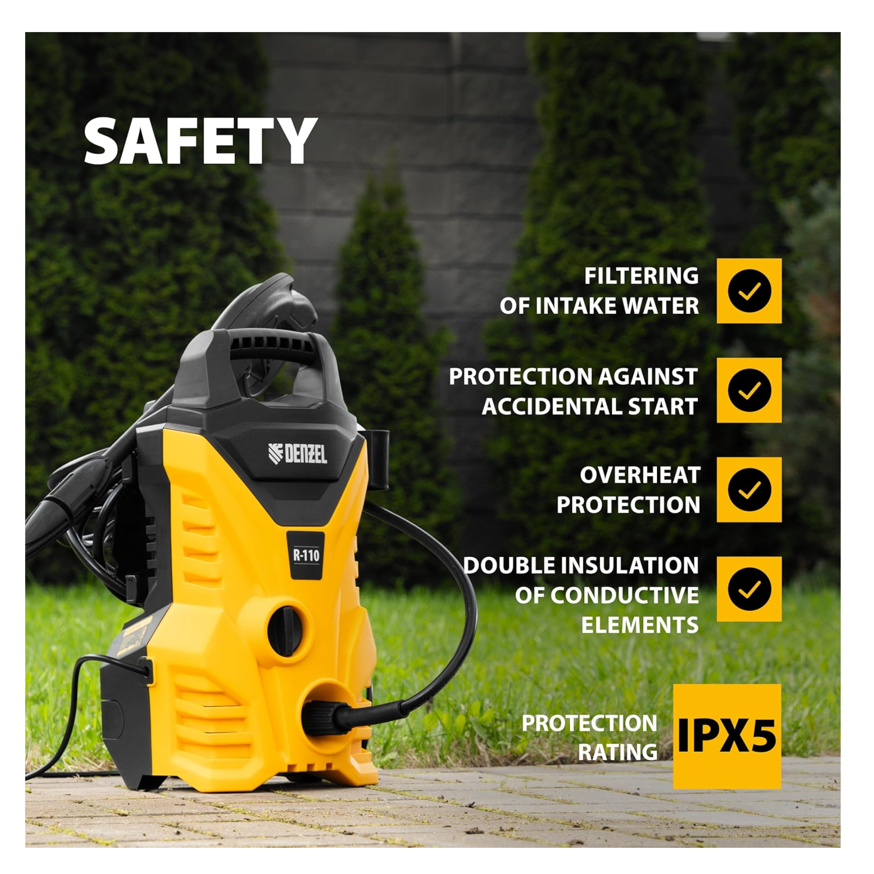Yellow and black pressure washer with safety features listed on a grassy background