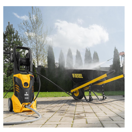 DeWalt pressure washer cleaning a black wheelbarrow outdoors.
