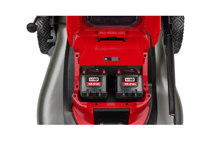 Close-up of a red and black power tool with battery compartments on a white background