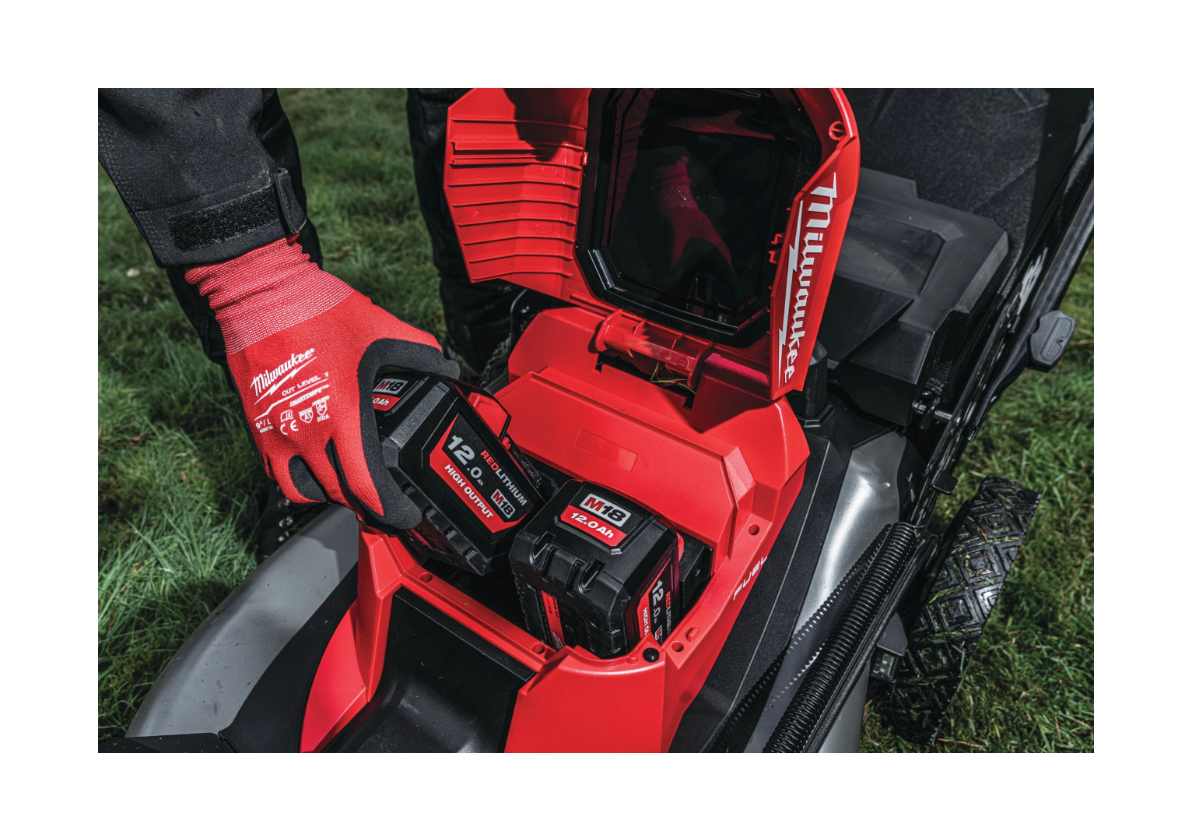Red and black Milwaukee tool on a grassy background
