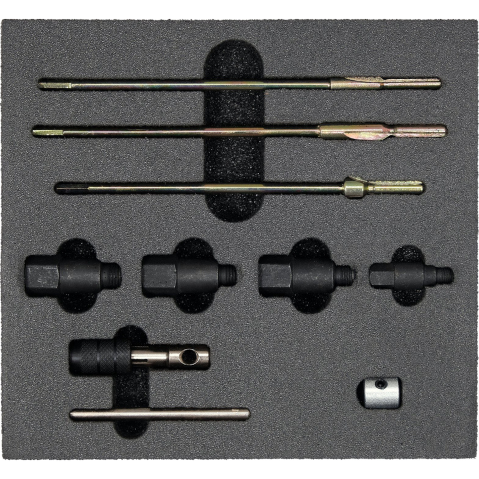 Set of drill bits and related tools on a gray foam block