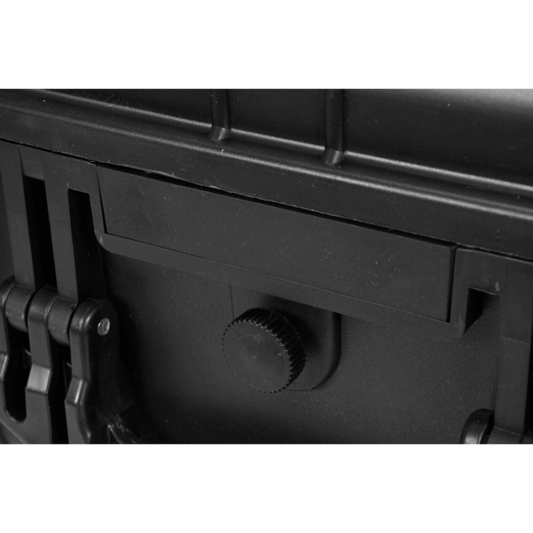 Close-up of a black metal object with a cylindrical component on a white background