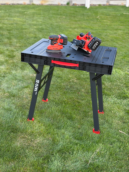 Portable workbench with tools on a grassy outdoor area