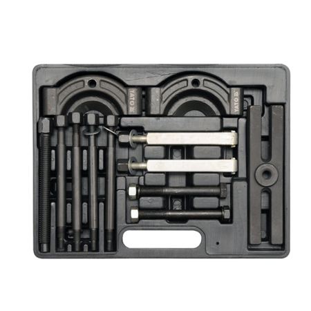 A black metal tool set organized in a molded plastic case, featuring various bolts, rods, and circular metal components on a plain white background.