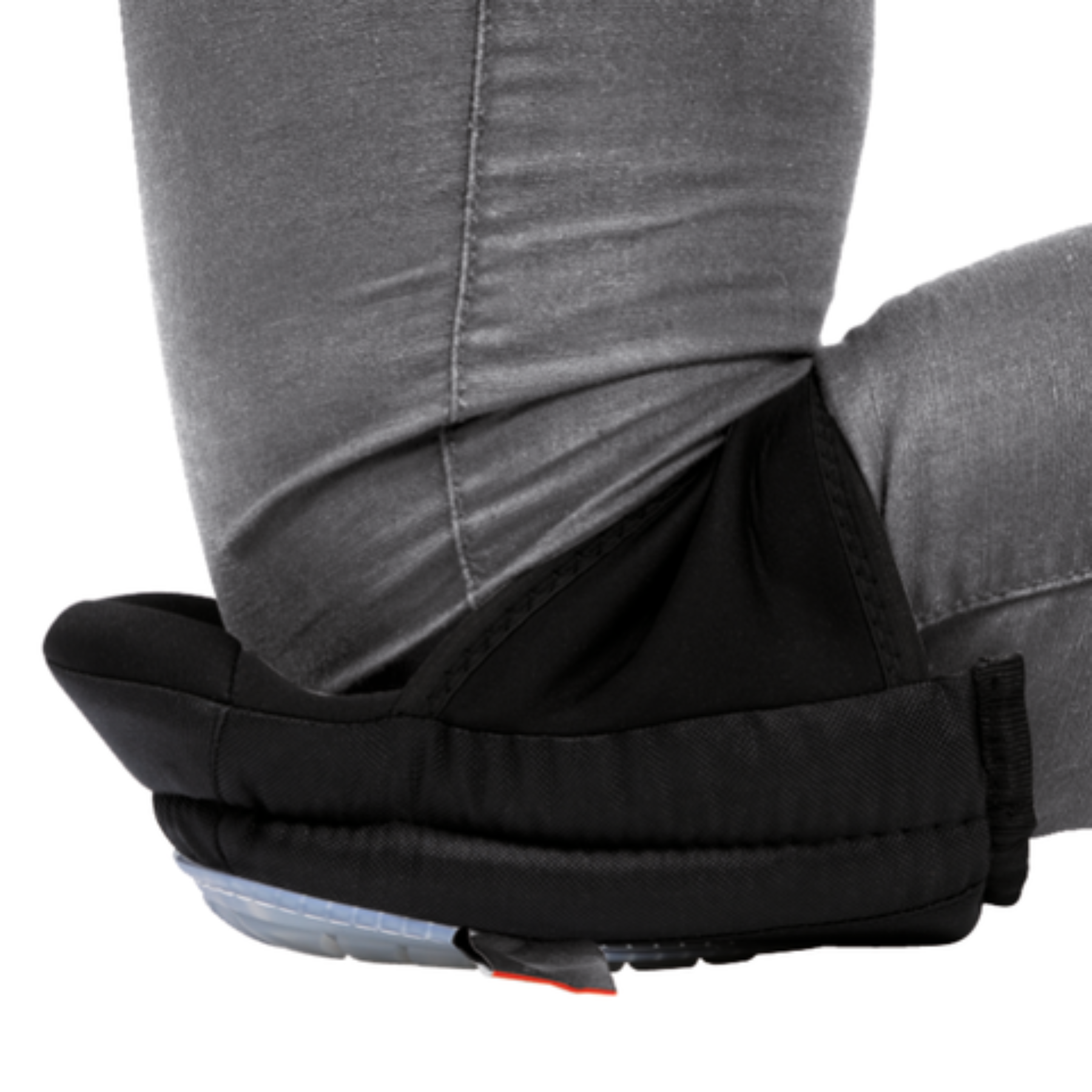 Black foot cover over gray pants on a white background