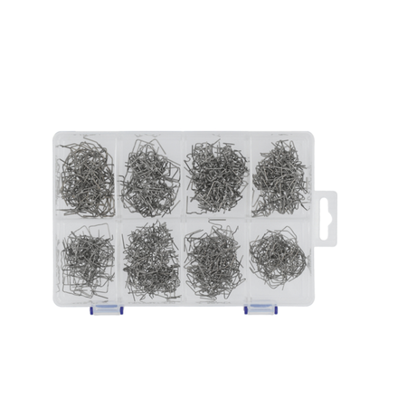 Assorted metal pins in a clear plastic organizer on a white background